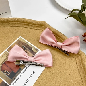 Pair of sweet pink satin bow hair clips with silver alligator clips for women and girls