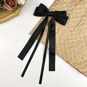 Elegant black satin ballet-style hair bow clip with long ribbon streamers