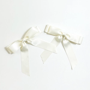 Detail of cream satin ribbon bows with smooth silk finish and double-loop elegant design