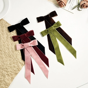 Détail des barrettes à nœuds en velours avec de longs rubans en plusieurs couleurs