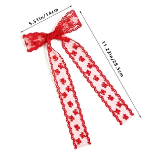 Detailed view of red lace bow hair clip with hollow floral pattern and size dimensions