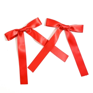 Pair of red satin ballet bow hair clips with long streamers for elegant styling