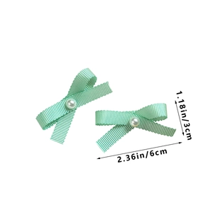 Detailed view of mint green ribbon bow hair clips with pearls and size measurements