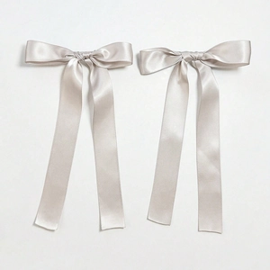 Pair of light grey satin bow hair clips with long ribbons in elegant ballet style