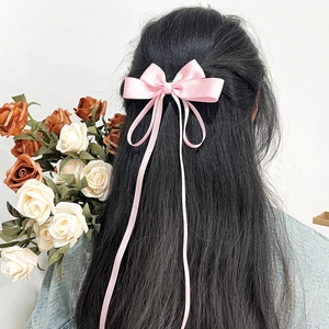 Pink satin ribbon bow hair clip with long streamers for elegant women hairstyling
