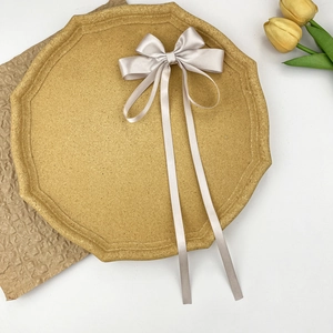 Detail of elegant champagne satin ribbon bow hair clip with soft silk texture and long tails