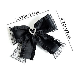 Detailed view of black lace heart bow hair clip with silver rhinestone, 13x12cm size label