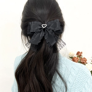 Elegant large black satin lace bow hair clip with heart rhinestone on long curly hair