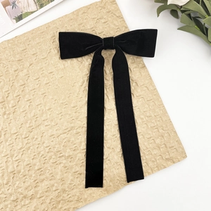 Elegant black velvet bow hair clip with long ribbons in a French vintage style design