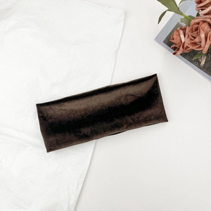 Close-up of a wide brown velvet sports headband featuring soft texture and satin sheen