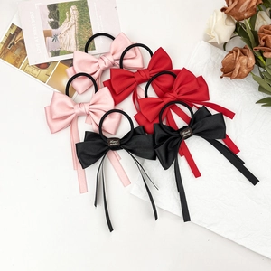 Elegant satin bow hair scrunchies with long streamers in pink, red and black