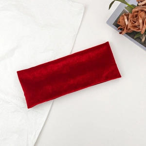 Deep red velvet headband for sports and daily wear on a minimalist textured background