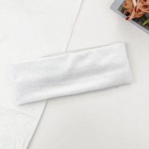 Detailed view of white ribbed knitted headband texture on minimalist aesthetic background