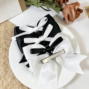 Elegant set of black and white satin ribbon bow hair clips with silver alligator grips