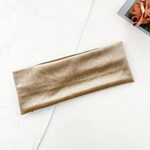 Detailed macro view of champagne velvet headband with fine ribbed striped texture
