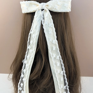 Gros plan détaillé d'un nœud papillon en dentelle crème avec broderie florale