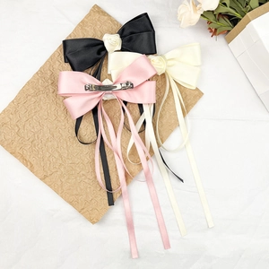 Elegant satin bow hair clip set with silk roses and long ribbons in pink, black, and white