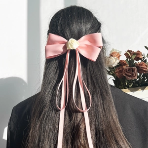 Elegant large pink silk bow hair clip with cream rose and long flowing ribbons