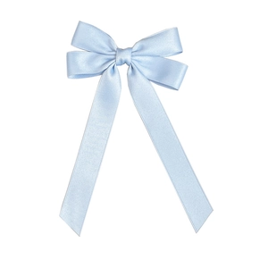 Close-up of light blue satin bowknot hair clip with long ribbons on white background