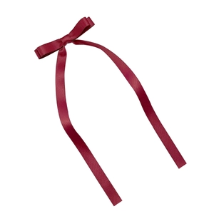 Elegant deep red satin ribbon bow hair clip with long streamers on white background