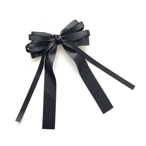 Elegant multi-layered black satin ribbon hair bow with long streaming tails for women