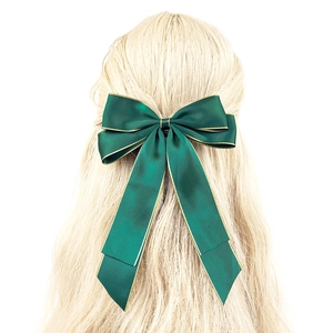 Elegant dark green satin bow hair clip with gold edges and long ribbons for women
