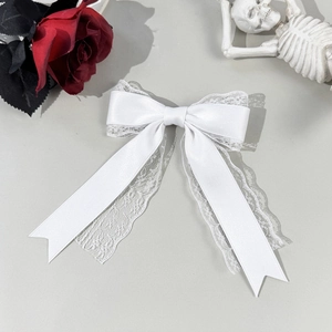 Detail of white lace bow hair clip with ribbons for gothic and lolita style