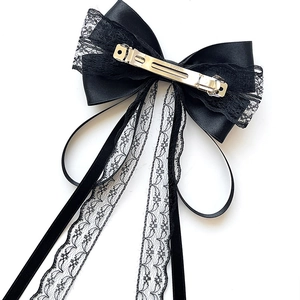 Elegant black lace bow hair clip with long ribbons and a silver metal clasp