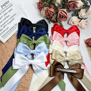 Elegant satin bow hair clips in multiple colors with sleek metal alligator fasteners