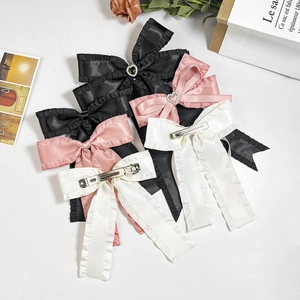 Elegant satin bow hair clip set with ruffle edges and heart charms in black, pink and white