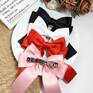 Set of four multi-layer satin bow hair clips in black, white, red, and pink colors