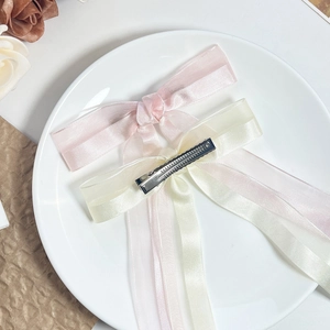 Elegant tulle bow hair clips in pink and beige, featuring metal duckbill clips for women