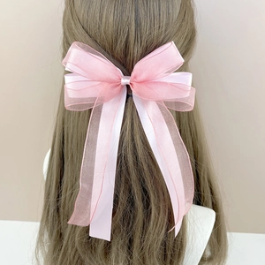 Detail showing layers of pink organza and satin ribbon on large elegant bow hair clip