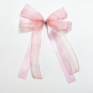Elegant pink mesh bow hair clip with flowing ribbons for women made of satin and organza