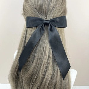 Elegant large black satin bow hair clip with long ribbons for back-of-head styling