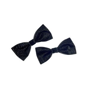 Pair of sparkling black bow hair clips with silver glitter finish on white background