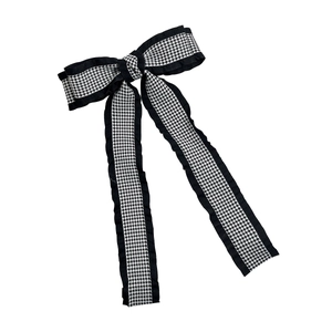 Elegant houndstooth ribbon bow hair clip with long streamers on a white background