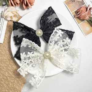 Elegant hollow lace bow hair clips with square pearl and rhinestone details in black and white