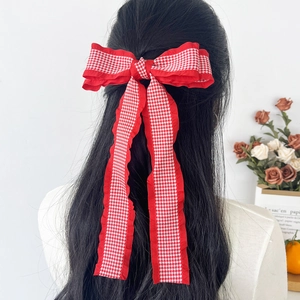 French style red houndstooth bow hair clip with long ribbons and ruffled edges on hair