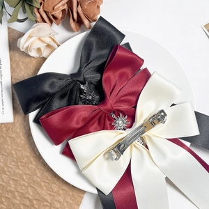 Three-piece satin bow hair clips with vintage sun pendants in black, burgundy, and beige