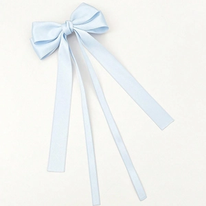 Close-up of the light blue satin bow hair clip featuring elegant long hanging ribbons