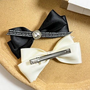 Elegant bow hair clip set with satin ribbon and crystal rhinestones in black and cream