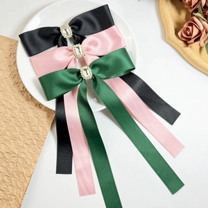 Elegant satin bow hair clips with rhinestones in black, pink, and forest green colors
