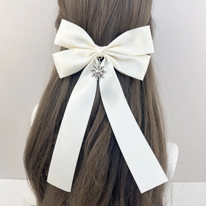 Elegant cream satin bow hair clip with vintage sun pendant and long flowing streamers