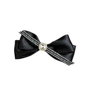 Elegant black satin bow hair clip with crystal rhinestone center and script lettering