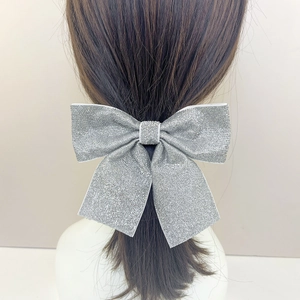 Sparkling silver glitter bow hair clip with a retro minimalist style for elegant hair styling