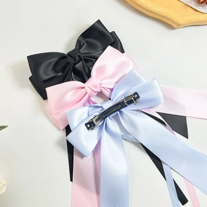 Three-piece satin bow hair clips with long ribbons in black, pink and light blue colors
