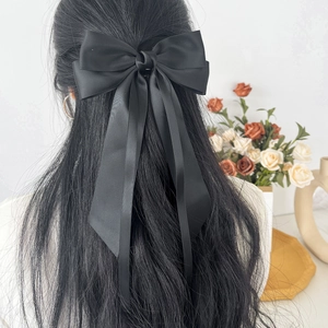 Elegant black satin bow hair clip with long ribbons for French style hairstyles