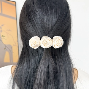 French vintage off-white satin rose flower hair clip for an elegant back-of-head hairstyle