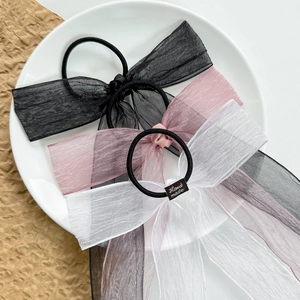 Three-color organza bow hair tie set in black, pink, and white with handmade labels